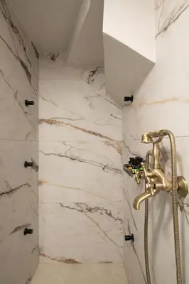 a bathroom with a shower and a shower head at Nobili Boutique Hotel in Chania Town