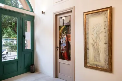 a doorway with a green door and a picture on the wall at Nobili Boutique Hotel in Chania Town