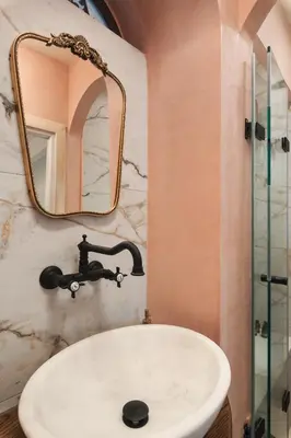 a bathroom with a sink and a mirror at Nobili Boutique Hotel in Chania Town