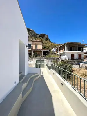 a balcony with a view of a house at Lithos Retreat (ΛΙTHOS Retreat) in Kolymvari