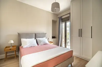 a bedroom with a large bed and a window at Amalthia Casa by 8essentially in Chania Town