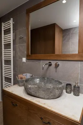 a bathroom with a large stone sink on a counter at Amalthia Casa by 8essentially in Chania Town