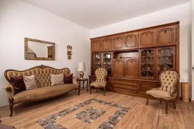 a living room with a couch and chairs and a cabinet at Vintage project house in Kalyves