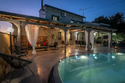 a backyard with a swimming pool and a pergola at Casa Del Miele, private pool, BBQ, mountain view. in Alikianós