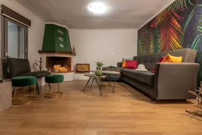 a living room with a couch and a fireplace at Casa Del Miele, private pool, BBQ, mountain view. in Alikianós