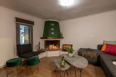 a living room with a couch and a fireplace at Casa Del Miele, private pool, BBQ, mountain view. in Alikianós