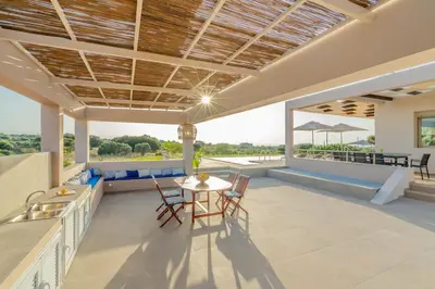 an outdoor kitchen and dining area of a house at Villa Anastasia with private heated pool and privacy in Chania Town