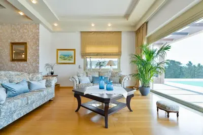 a living room with a couch and a table at Villa Anastasia with private heated pool and privacy in Chania Town
