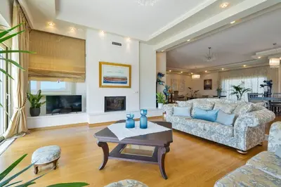 a living room with a couch and a table at Villa Anastasia with private heated pool and privacy in Chania Town