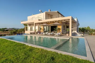 a villa with a swimming pool in front of a house at Villa Anastasia with private heated pool and privacy in Chania Town