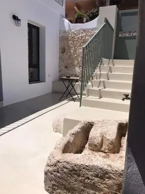 a building with stairs and a stone bowl on the floor at Lithos Retreat 2(ΛΙTHOS Retreat) in Kolymvari