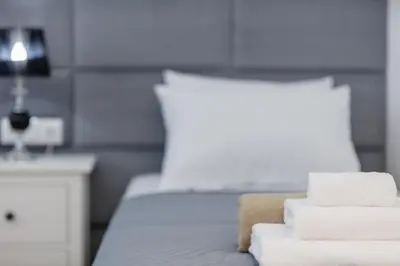 a pile of towels sitting on top of a bed at Adelphes Beachfront Apartment with direct connection to the beach in Chania Town
