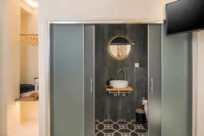 a bathroom with a glass door with a sink at Belle Epoque Halepa's House & Studio in Chania Town