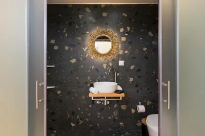 a bathroom with a mirror and a sink at Belle Epoque Halepa's House & Studio in Chania Town