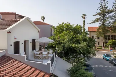 a view from the balcony of a house with a table and umbrella at Belle Epoque Halepa's House in Chania Town