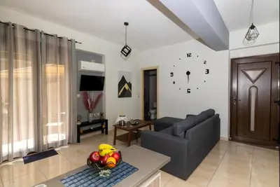 a living room with a couch and a table at Callisto in Chania Town