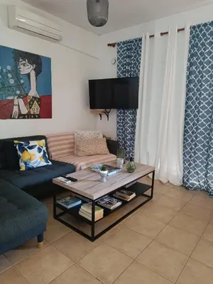 a living room with a couch and a coffee table at Origeo casa in Maleme
