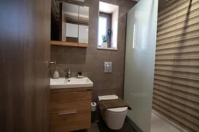 a bathroom with a toilet and a sink and a mirror at Villa Konstantinos in Azoyirás