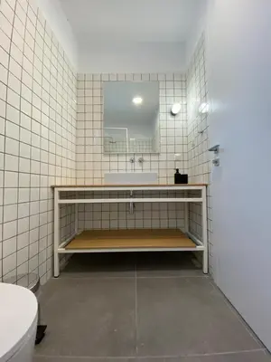 a bathroom with a sink and a mirror at Lefko Apartments in Tavronitis