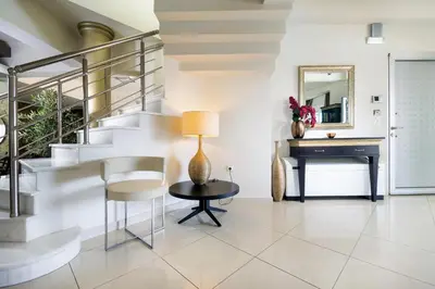 a living room with stairs and a table and a piano at Epavlis Akrotiri in Chania Town