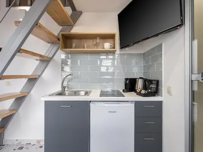 a small kitchen with a sink and a staircase at Cretan Berry Kondylaki in Chania Town