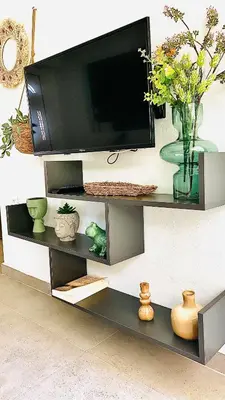 a entertainment center with a television on a wall at Ivy, 4 minutes from the sea in Chania Town