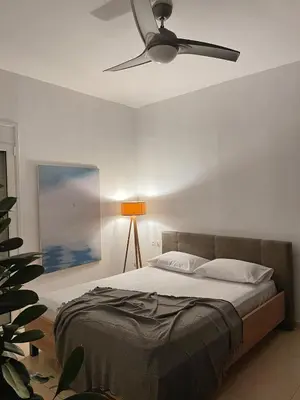 a bedroom with a bed with a ceiling fan at FLAT 45 in Kounoupidhianá