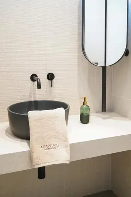 a bathroom with a black sink and a mirror at AGAVE HILL LUXURY HOUSE in Chania Town