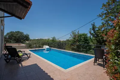 a swimming pool in a villa with a view at Villa Festos in Voúvai