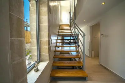 a staircase in a house with wooden steps at Aiolos Executive Suite in Galatás