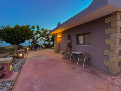 a house with a table and chairs outside of it at Beautiful Life Rooms with Sea View - Next to Elafonisi Beach in Elafonisi