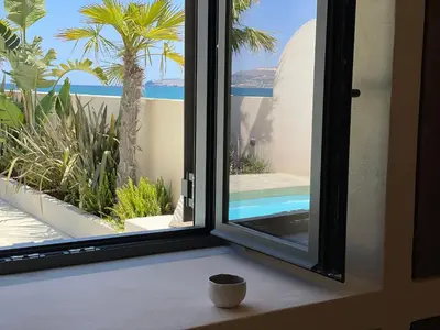 a window with a view of a swimming pool at Kaliva Residence in Kalyves
