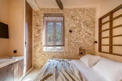 a bedroom with a white bed and a window at Kaliva Residence in Kalyves
