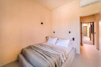 a bedroom with a bed with a blanket on it at Kaliva Residence in Kalyves