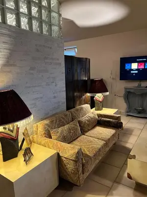 a living room with a couch and two tables at The Twin Pines Home in Kounoupidhianá