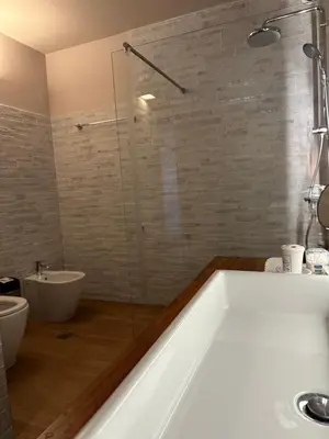 a bathroom with a bath tub and a sink at The Twin Pines Home in Kounoupidhianá