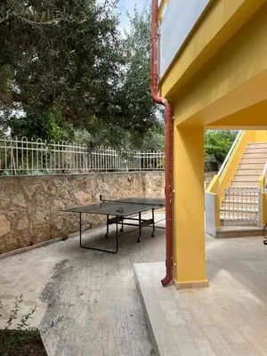 a picnic table sitting on a patio next to a building at The Twin Pines Home in Kounoupidhianá