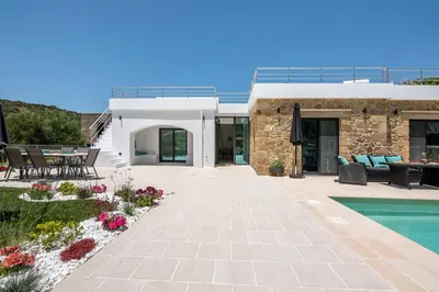 a house with a patio and a swimming pool at White House Boutique in Koukounará