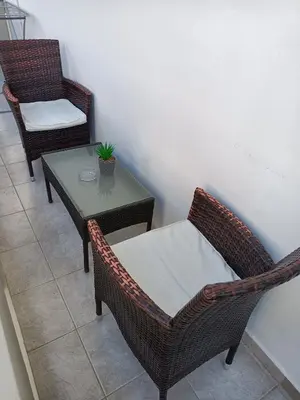 two wicker chairs and a table with a plant on it at Virma Studio in Chania Town