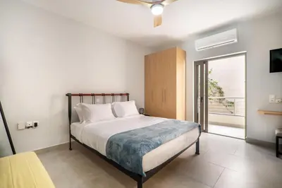 a bedroom with a bed and a sliding glass door at Cozy Spot near the beach in Plataniás