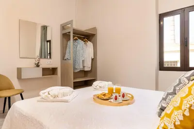 a room with a bed with a tray of food on it at Strat's City Loft in Chania Town