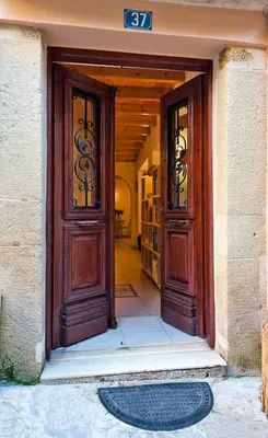 an entrance to a building with two wooden doors at Odyssey House in Chania Town