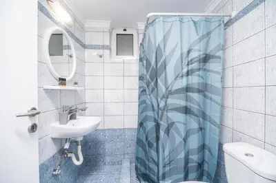 a bathroom with a sink and a shower curtain at ''Meraviglia casa'' Christin in Kato Daratso