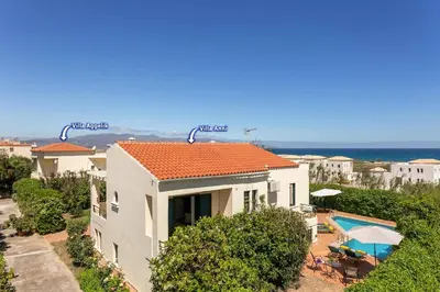 a large white house with a swimming pool and a house at Villa Anni by Villa Plus in Pírgos Psilonérou