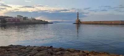 a view of a body of water with buildings and a lighthouse at Georgia's House Chania in Chania Town