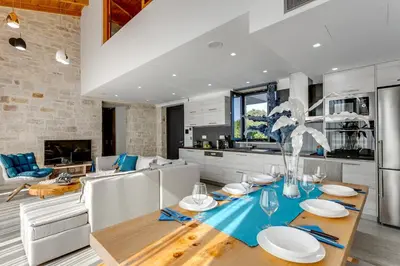 a kitchen and dining room with a table and chairs at Villa Potami Angela by Villa Plus in Stílos