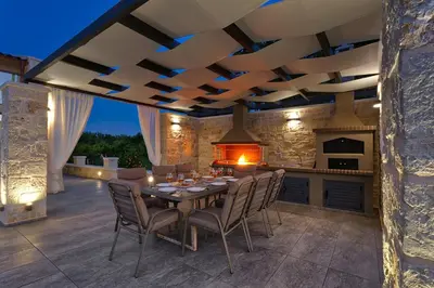 a kitchen and dining room with a table and chairs at Villa Potami Angela by Villa Plus in Stílos