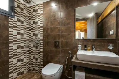 a bathroom with a sink and a toilet and a mirror at Villa Potami Nikos by Villa Plus in Stílos