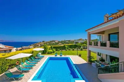 a villa with a swimming pool and a house at Villa Margarita Exi by Villa Plus in Kalyves