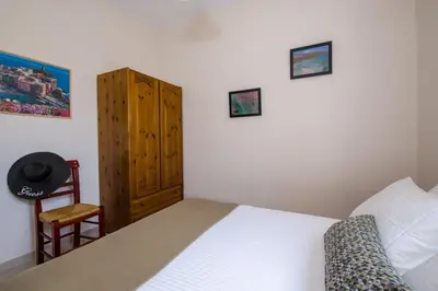a bedroom with a bed and a wooden cabinet at Villa Ciel in Agios Padeleimon